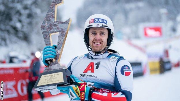 Dave Ryding holds a trophy and celebrates his victory in the World Cup slalom event in Kitzbuhel, Austria