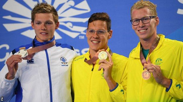 Duncan Scott (left) shows off his silver medal as he shares the podium with Mitch Larkin and Clyde Lewis