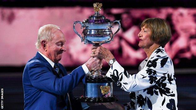 Rod Laver presents Margaret Court with a replica of the Australian Open trophy to commemorate 50 years since she won all four major titles in a calendar year