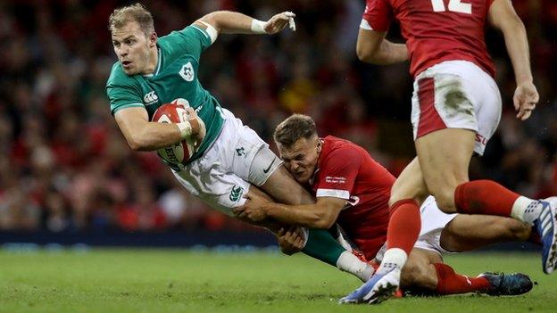 Will Addison is tackled by Wales' Jarrod Evans during the World Cup warm-up game in Cardiff last August