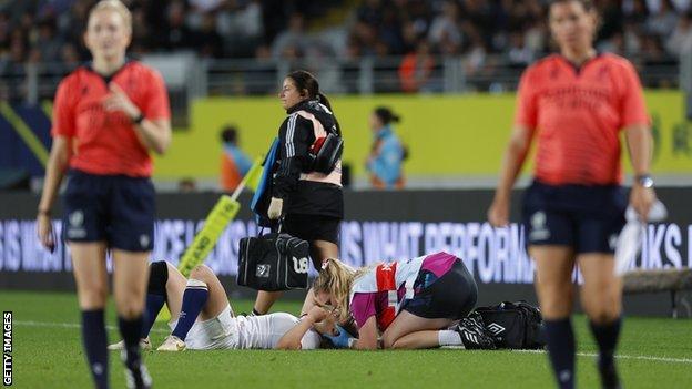 Abby Dow receives medical attention during the Rugby World Cup final