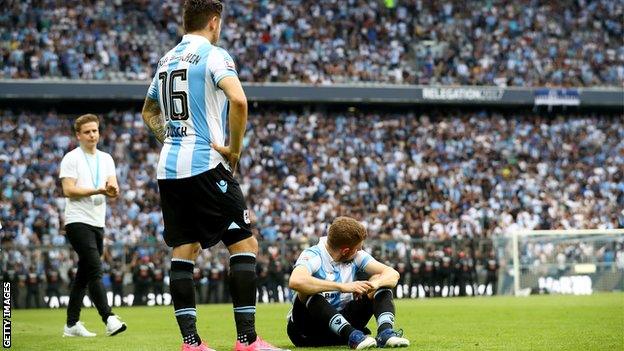 1860 Munich players react after being relegated to Germany's third tier