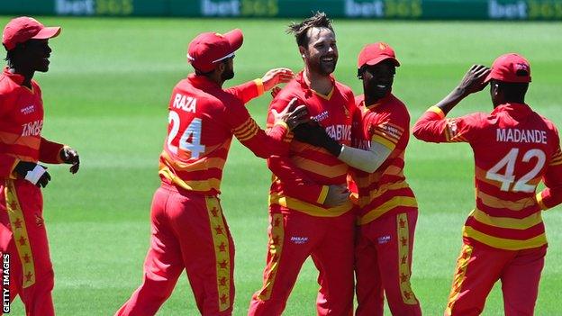 Zimbabwe spinner Ryan Burl celebrates taking a wicket against Australia