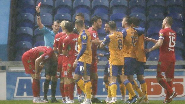 Wimbledon defender Chris Gunter was sent off during the League Two match against Mansfield Town