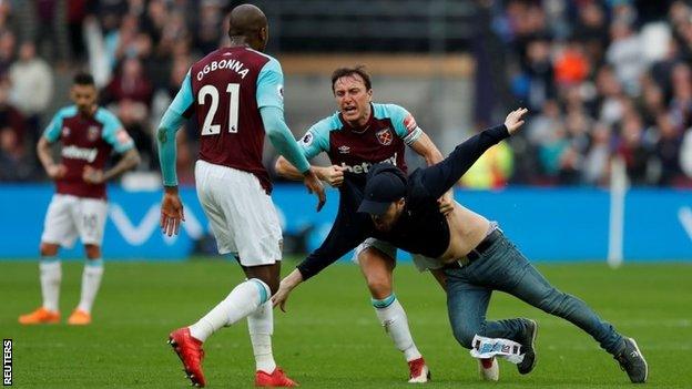 Mark Noble confronts a supporter during the match against Burnley