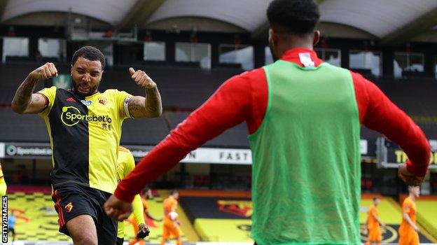 Troy Deeney celebrates after scoring his second penalty against Newcastle