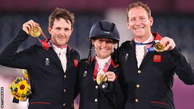 Britain's Tom McEwen, Laura Collett and Oliver Townend pose with their gold medals at the Tokyo Olympics