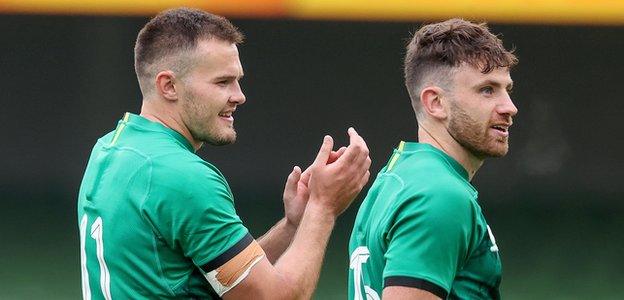 Jacob Stockdale and Hugo Keenan applaud the crowd at Dublin's Aviva Stadium