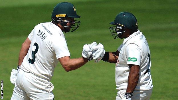 Nottinghamshire batsmen Chris Nash and Samit Patel touch gloves