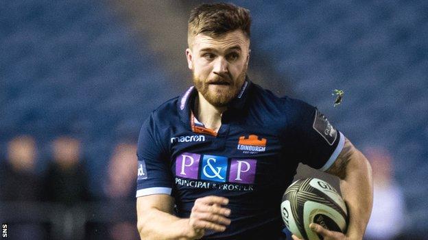 Luke Crosbie runs with the ball for Edinburgh