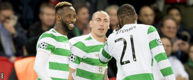 Celtic striker Moussa Dembele (left) celebrates against PSG