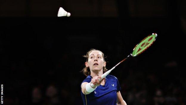 Kirsty Gilmour preparing to hit a shuttle on court