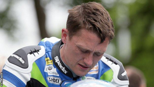 Dean Harrison shows his disappointment after his exit from the Superbike race