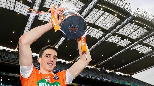 Armagh captain Rory Grugan holds the Division Three trophy aloft after his team's win