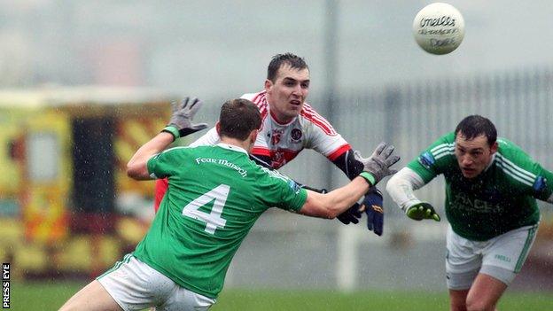 Derry's Ryan Bell is challenged by Fermanagh's Che Cullen with Eoin Donnelly also pictured