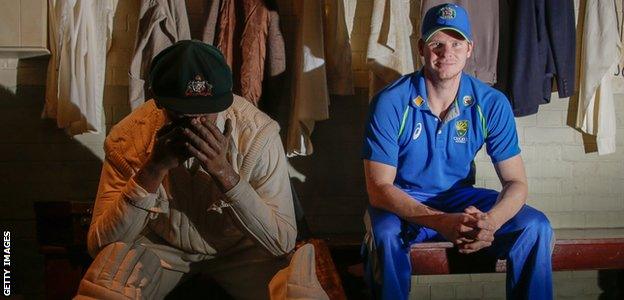 Steve Smith sits beside a model of Donald Bradman