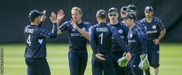 Josh Davey is congratulated after taking one of his three wickets in Edinburgh