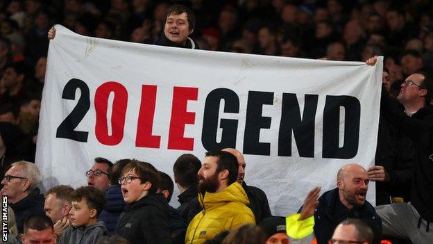 Ole Gunnar Solskjaer banner being held up by Manchester United supporters