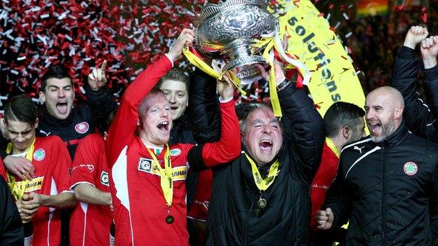 Cliftonville captain George McMullan and manager Tommy Breslin celebrate League Cup success