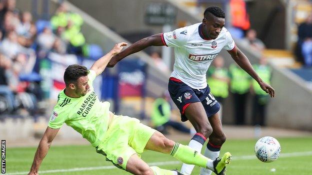 Bolton Wanderers' Sammy Ameobi competing with Sheffield United's Enda Stevens