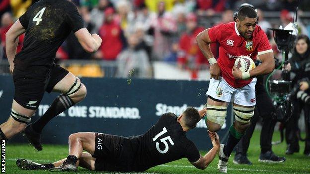 Taulupe Faletau busts the tackle of Israel Dagg to score for the Lions in Wellington