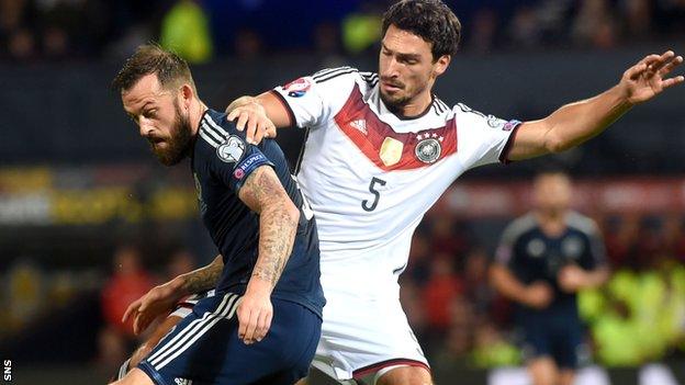 Steven Fletcher is tackled by Germany's Mats Hummels