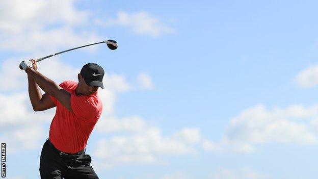 Tiger Woods tees off