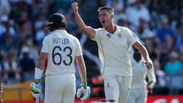 South Africa all-rounder Dwaine Pretorius (right) celebrates taking the wickets of England batsman Jos Buttler (left) on day one of the second Test in Cape Town