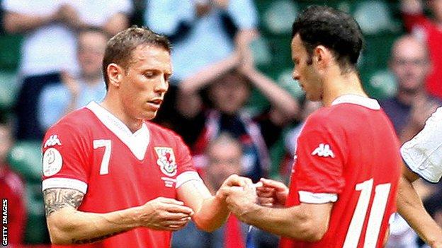 Craig Bellamy accepts the Wales captain's armband from Ryan Giggs as the Manchester United player bows out from international football in 2007