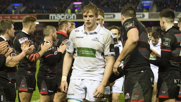 Glasgow lock Jonny Gray looks downcast as Edinburgh players applaud his side off at Murrayfield