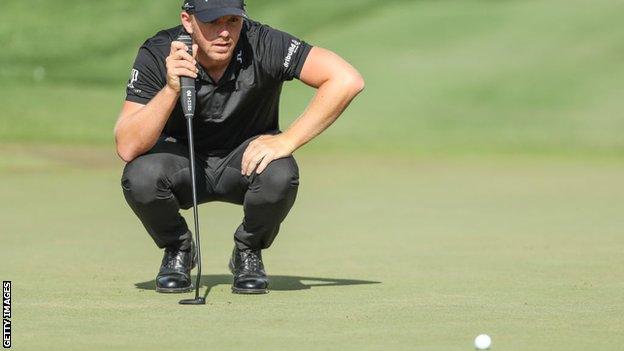 Matt Wallace lines up a putt on the fifth hole during the third round of the Players Championship