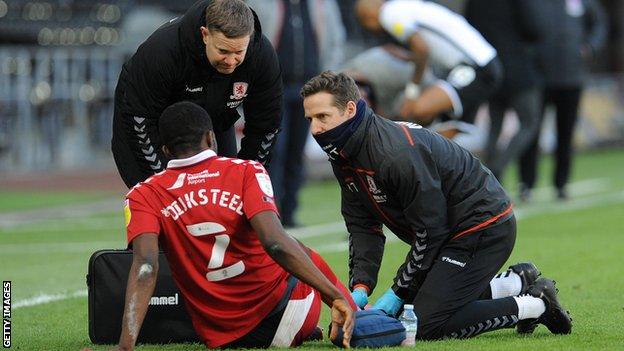 Anfernee Dijksteel has treatment on the pitch at Swansea