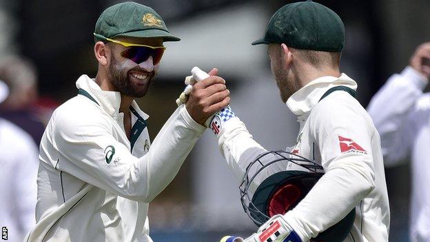 Nathan Lyon celebrates with Peter Nevill