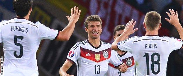 Thomas Muller is congratulated on opening the scoring for Germany at Hampden