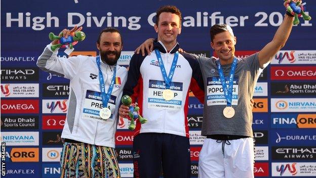 Catalin-Petru Preda of Romania poses with the silver medal, Aidan Heslop of Great Britain poses with the gold medal and Constantin Popovici of Romania poses with the bronze medal after the Men's High Dive Final during day five of the FINA World Swimming Championships