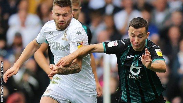 Swansea City's Besant Celina in action against Stuart Dallas of Leeds