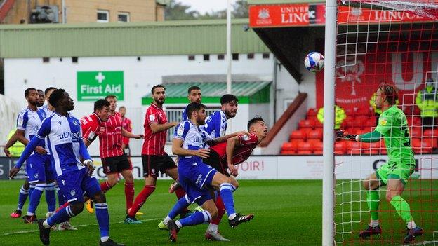 Jorge Grant's free-kick is headed home by Lewis Montsma for Lincoln