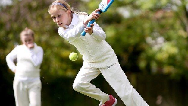 Girl playing cricket