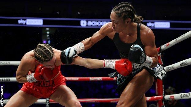 Alycia Baumgardner aims a punch from Mikaela Mayer