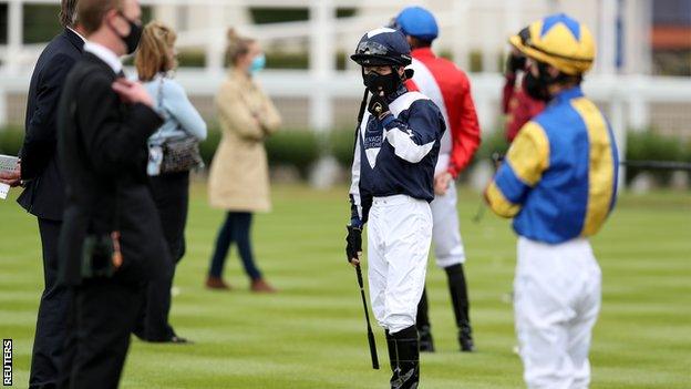 ockey Cieren Fallon wearing a protective face mask at Newmarket racecourse