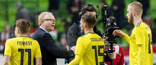 Alex McLeish greets his Scotland players following the March win in Hungary