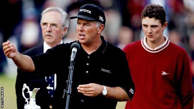 Mark O'Meara with Claret Jug watched by Justin Rose