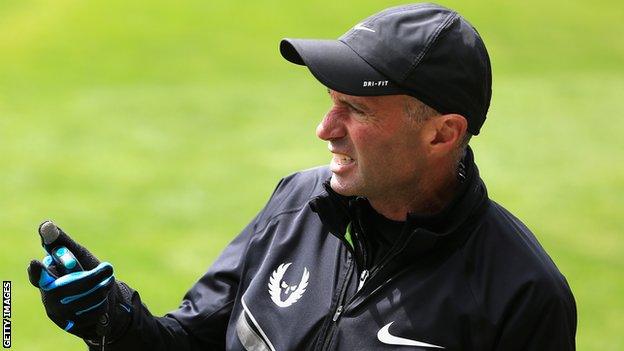 Alberto Salazar holds a stopwatch