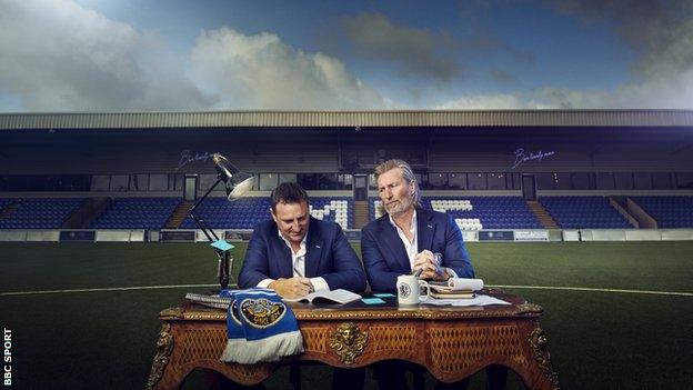 Robbie Savage and Rob Smethurst at a meeting table on the pitch at Moss Lane.