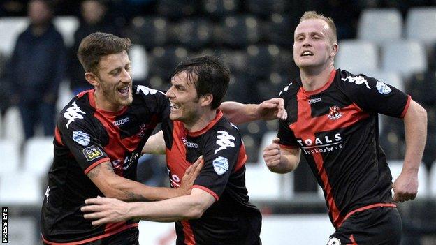 Crusaders players congratulate Philip Lowry after he opened the scoring at Seaview