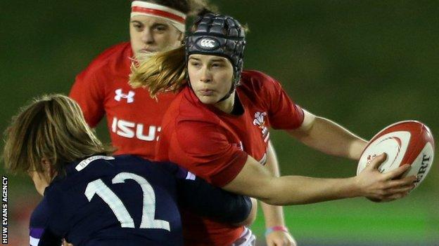 Beth Lewis of Wales is tackled by Scotland's Lisa Martin