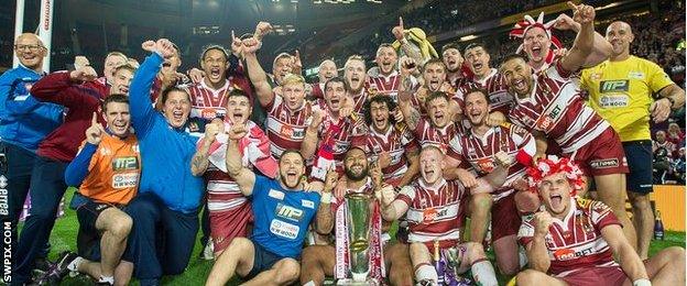 Wigan players and staff celebrate the Grand Final