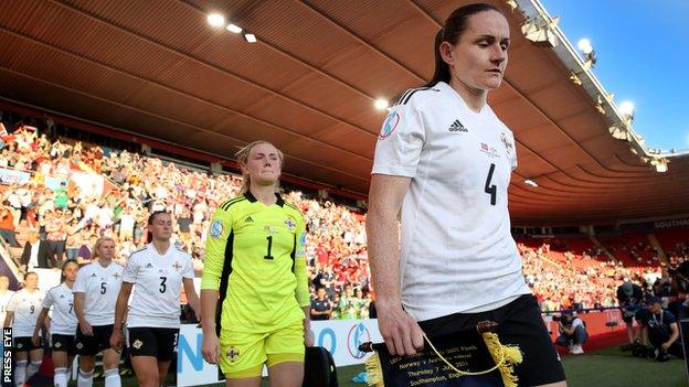 McFadden leads out Northern Ireland after Demi Vance (3) had to change her socks