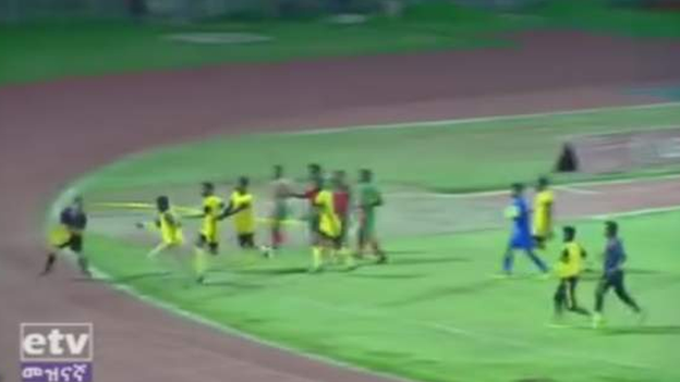 Welwalo Adigrat University chase down the referee after he awards a goal to opponents Defence