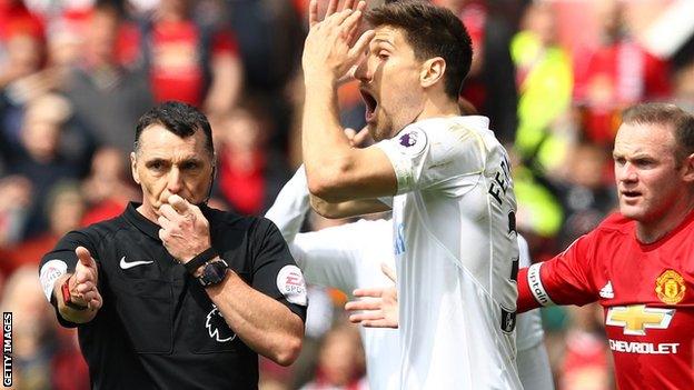 Referee Neil Swarbrick points to the spot to award a penalty to Manchester United against Swansea